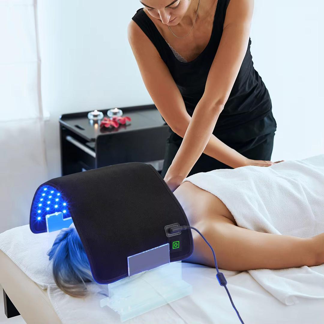 Esthetician using Spa Team LED Facial Arch in blue mode on client at treatment table